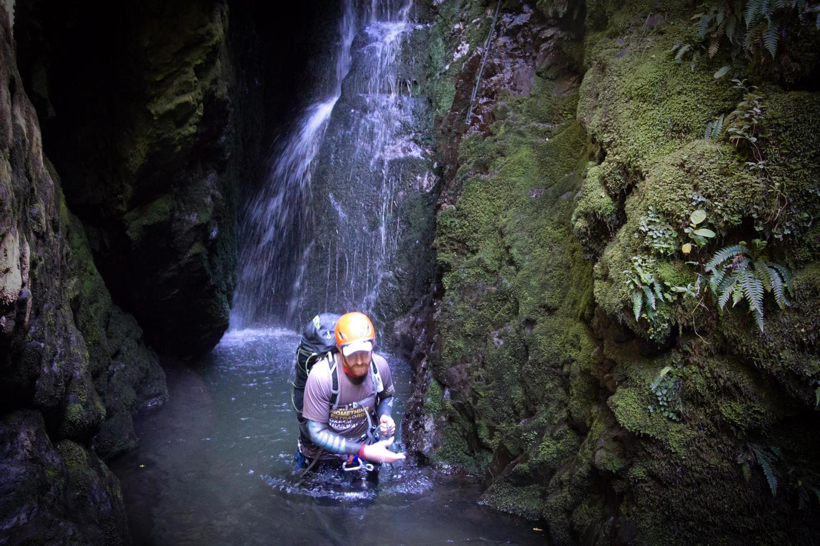 Wading through a pool at the bottom of a waterfall Chamberlain Creek