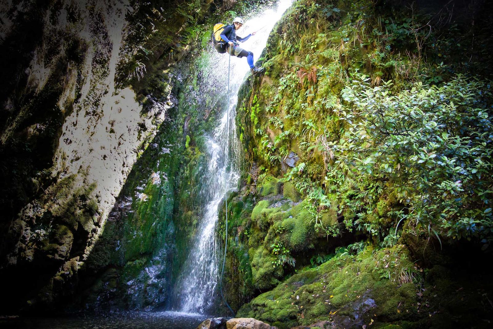 Abseiling down a water fall in Chamberlain Creek, Tararua Range