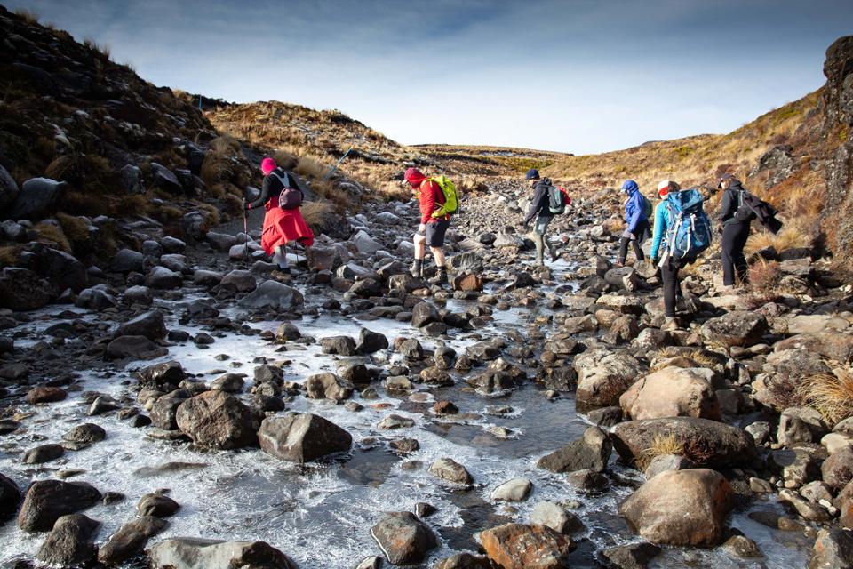 Crossing slippery ice covered rocks on the way to Tama Lakes
