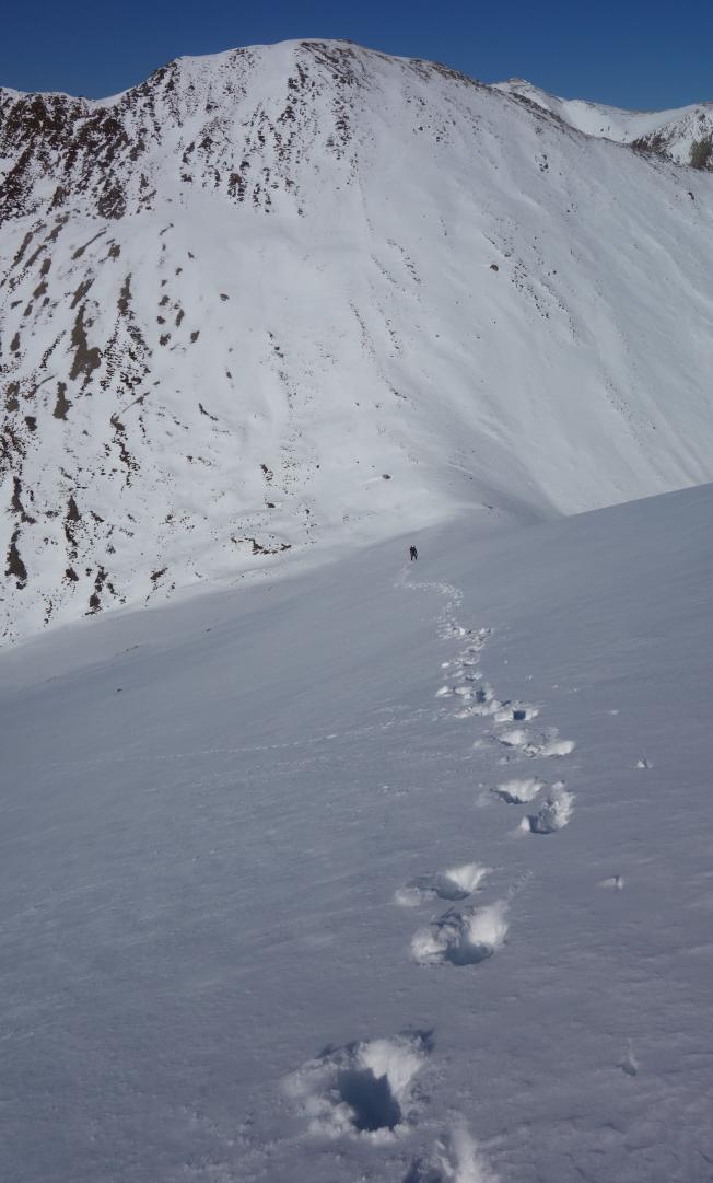 Looking down a snow covered mountain