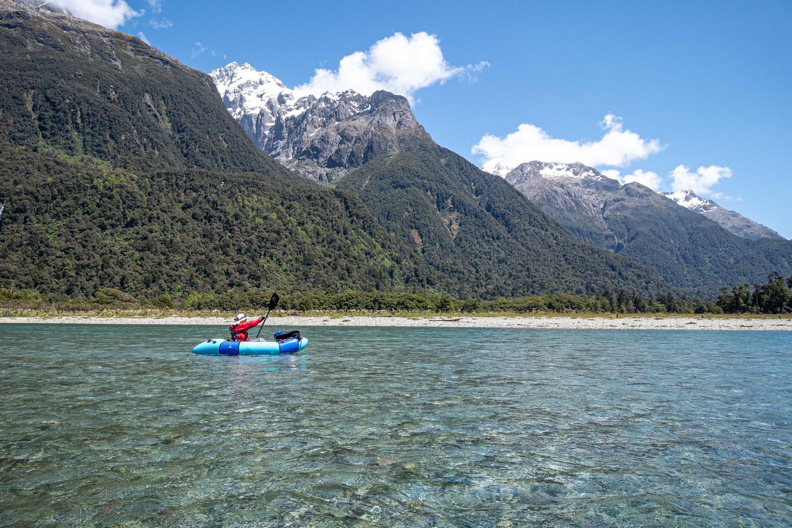 Paddling down the Hollyford River with spectacular scenery of the Darran Mountains