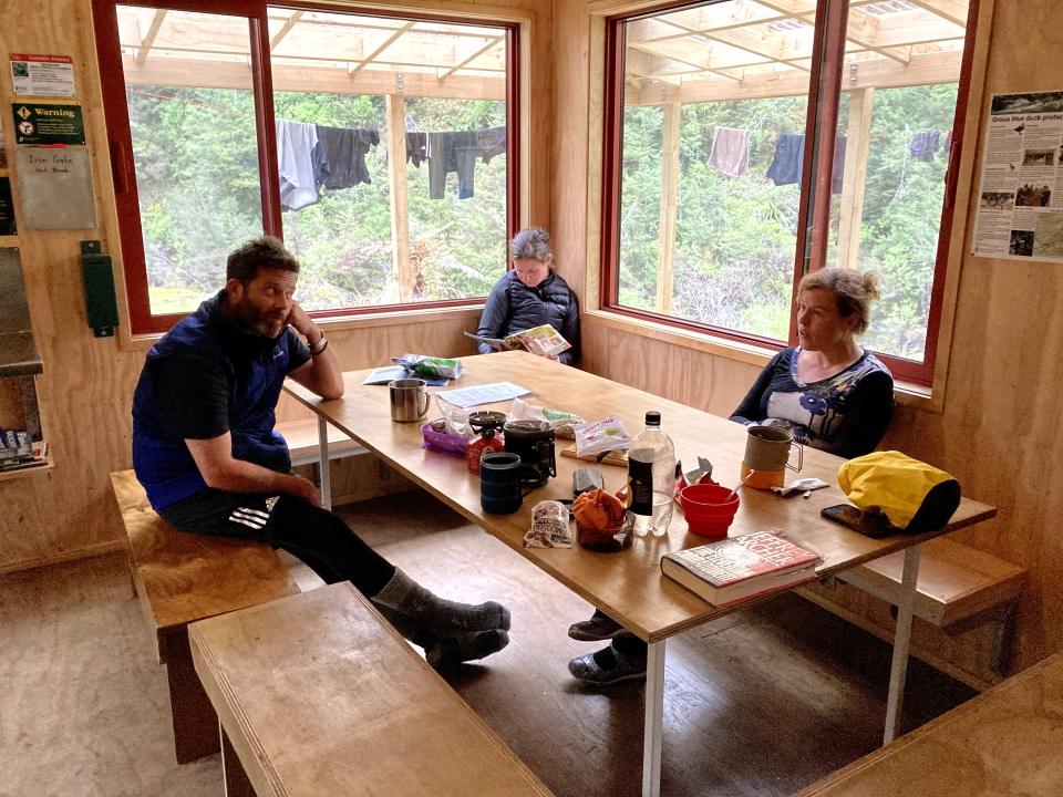 Trampers relaxing in Iron Gate Hut