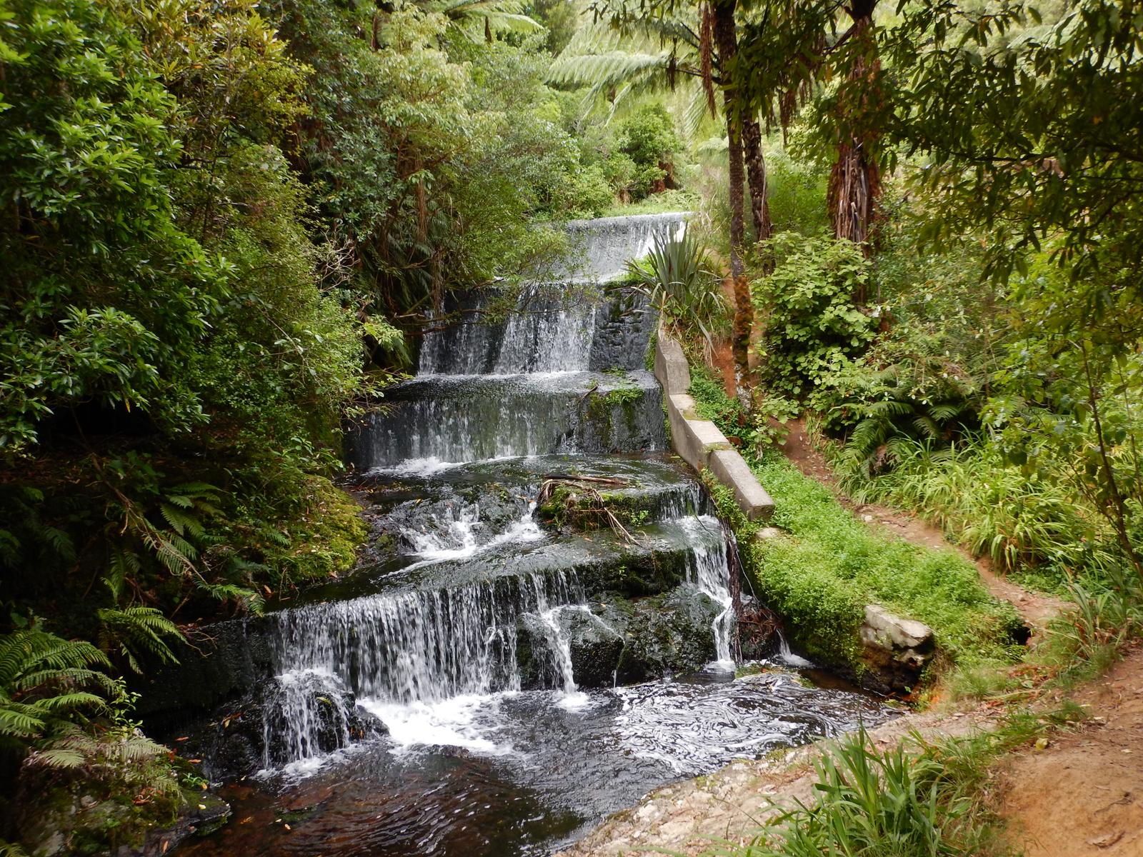 Water flows over a small dam