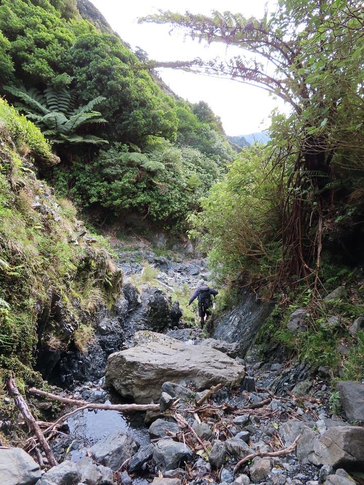 Tramper in a boulder-filled stream bed