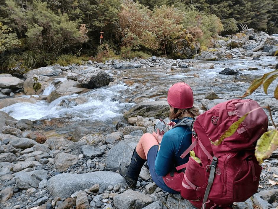 Emily has some morning tea at the crossing of Mistake Creek.