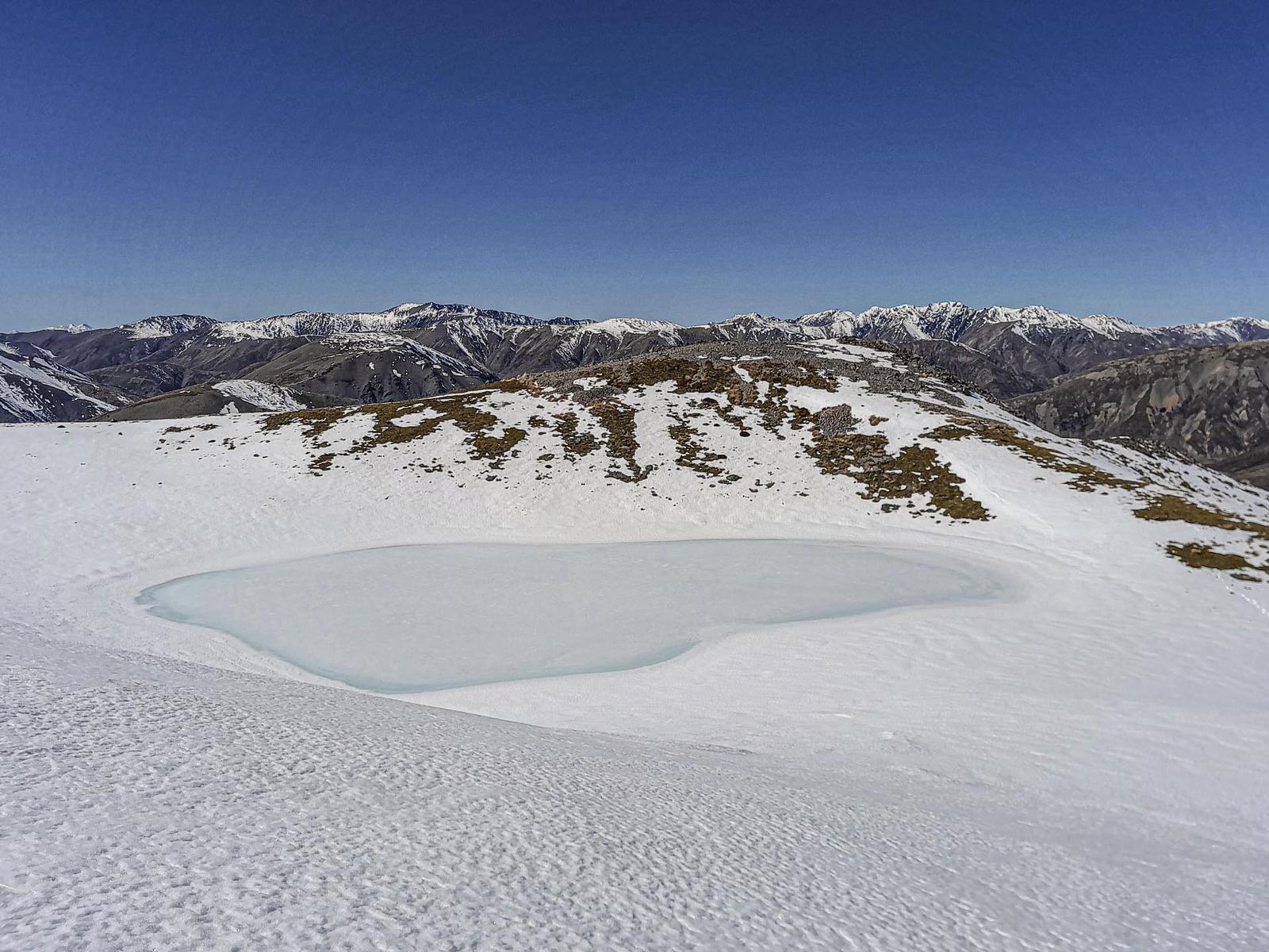 A frozen azure coloured tarn on Mt Princess