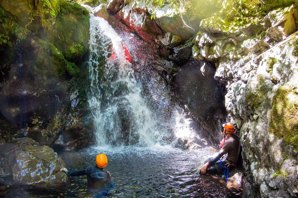 Climbing down behind a waterfall in Chamberlain Creek, Tararua Range