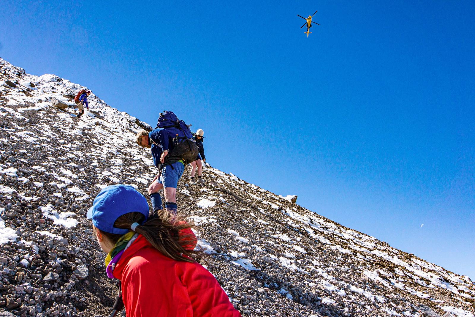 Beginning a retreat down Mt Taranaki as the rescue helicopter arrives