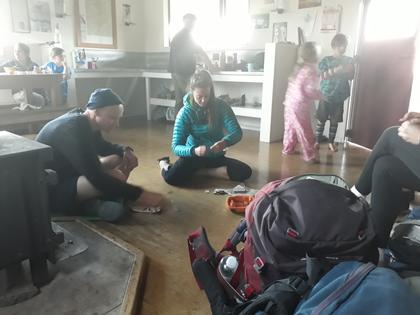 Trampers playing games in a hut