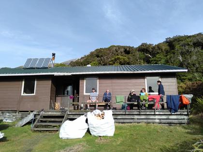 Group sitting outside Holly Hut