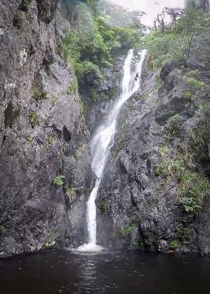 Megan with the gear bag descents the last 40 m waterfall Eager Beaver Canyon