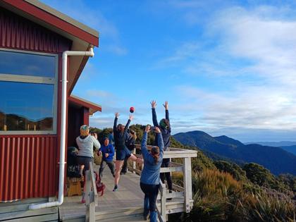 Impromptu netball warm up at Moonlight Tops Hut – Photo credit: Anna