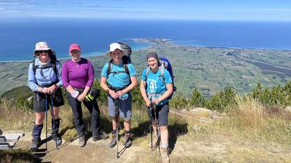 Four of the group at the summit. Kaikoura Peninsula in the background