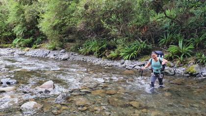 Tramper crossing a creek