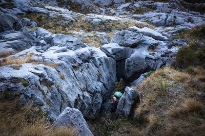 Climbing through a hole in the rock rather than over it on the way to Sunrise Peak