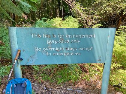 A very big sign telling us not to stay at the hut. Photo credit: Matt.