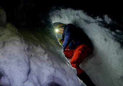 Preparing to go to bed in a snow cave
