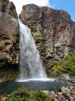 Walking behind Taranaki Falls