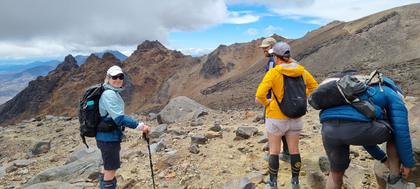 Emptying some scree off our boots on the way down (Credit: Chrys)