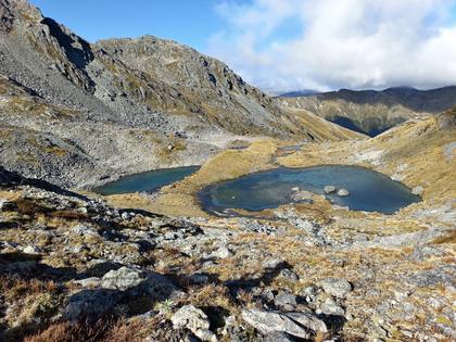 Arriving back at camp – you can just see our tents on the causeway between the two tarns. (Photo credit: Jamie).