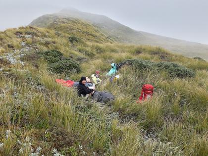 Jamie, Anna, and Loretha enjoy a welcome late lunch - tucked in out of the wind just below the ridge