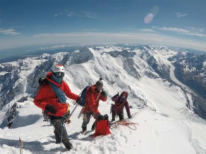 Elisabet, Nick and Adventure Consultant guide JB just below the summit, preparing to descend (credit: Annie Paras)