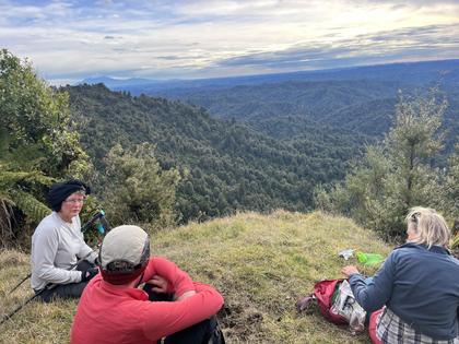 Enjoying views at the top of Mt Humphries. Mt Taranaki visible in the distance