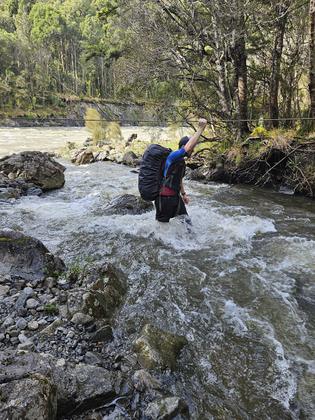 Michael crossing Bates stream. [Photo Credit – Zaw]