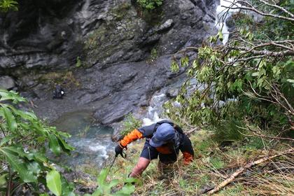 Emily scoping out potential routes around the waterfalls. Photo credit: Mathew D