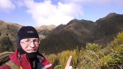 Tramper pointing at a spur he climbed