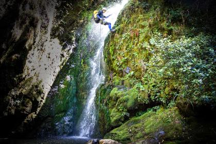 Abseiling down a water fall in Chamberlain Creek, Tararua Range