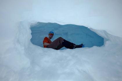 Lukas inside a cavern entrance to a snow cave