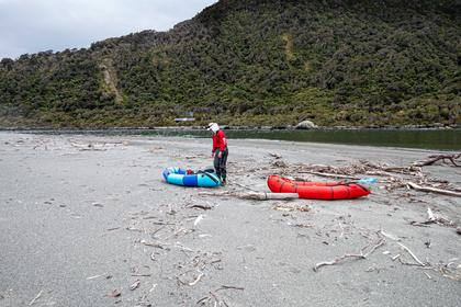 On the sandbar at Martins Bay Fiordland National Park - Martins Bay Hut behind