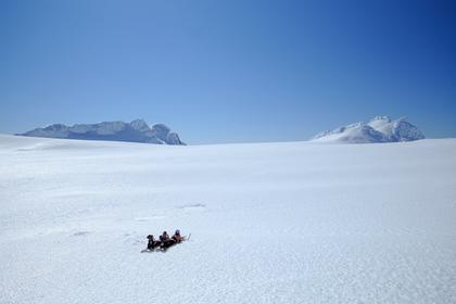Two people lying in the snow during a sunny day at Mt Ruapehu