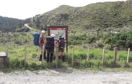 Everyone inspecting the map. The stile is to the left.