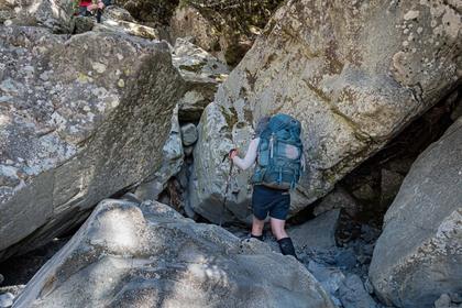 Tramper negotiating large boulders