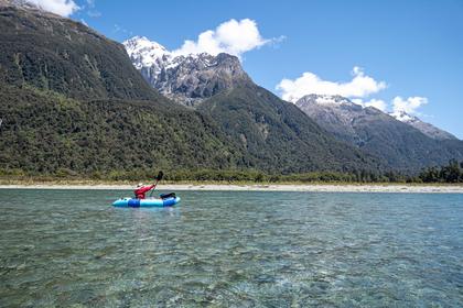 Paddling down the Hollyford River with spectacular scenery of the Darran Mountains