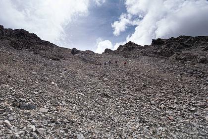 Five trampers descending a scree slope