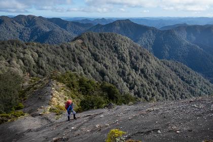 Megan makes her way up some scree as the sun starts to peep out. Photo credit: Ian.