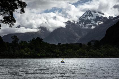 Nearing the end of Lake Alabaster with evening view of the Darran Mountains