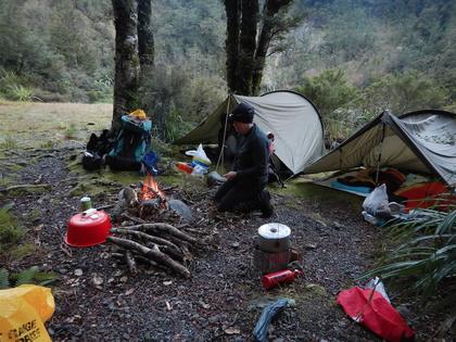 Marie working on building a fire at our campsite at Cow Creek